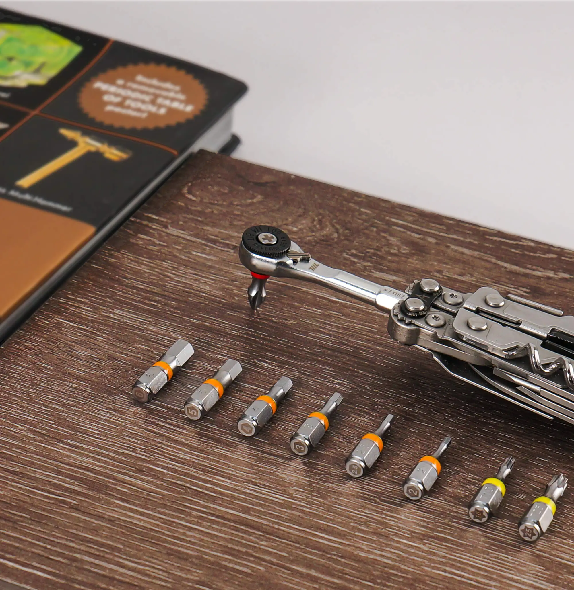 9pcs 711L hex bits from the color‑coded 1/4” set laid out on a wooden surface - includes H2 through H6, T10, T25, and Philips bits